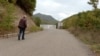 Stanimir Jovanović walking to concrete wall that the Kosovo Police erected on the territory of the municipality of Leposavic