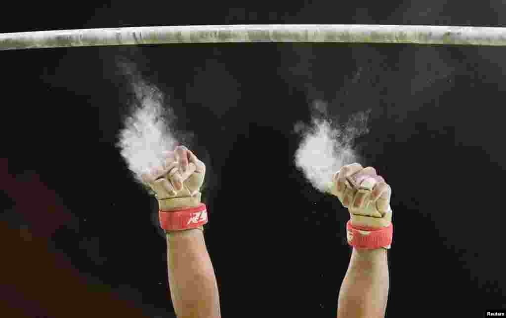 Japanese gymnast Kohei Uchimura loses his grip as he competes on the horizontal bar. 