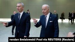 NATO Secretary-General Jens Stoltenberg (left) walks with U.S. President Joe Biden at an extraordinary summit at NATO headquarters in Brussels on March 24.