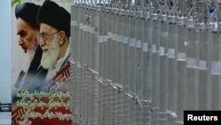 A poster of Iran's Supreme Leader Ayatollah Ali Khamenei (right) and the late Ayatollah Ruhollah Khomeini is seen next to a bank of centrifuges in what state TV described as a facility in Natanz.