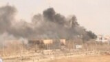 Дым от горящих зданий в Жанаозене. 16 декабря 2011 года. 