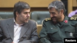 Revolutionary guards commander Mohammad Ali Jafari (right) speaks with Fereydoun Abbasi, the head of the country's Atomic Energy Organization, in Tehran in September 2011.
