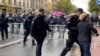 The police remove the girl in front of the cordon in Belgrade