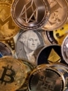 Representations of virtual cryptocurrencies are placed on U.S. Dollar banknotes in this illustration