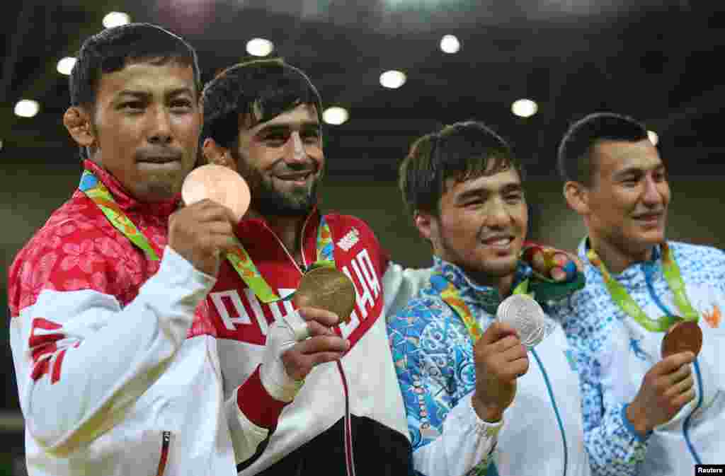 The victory ceremony for the men's 60-kilogram judo competition (left to right:) Naohisa Takato of Japan, Beslan Mudranov of Russia, Yeldos Smetov of Kazakhstan and Uzbekistan's Diyorbek Urozboev.
