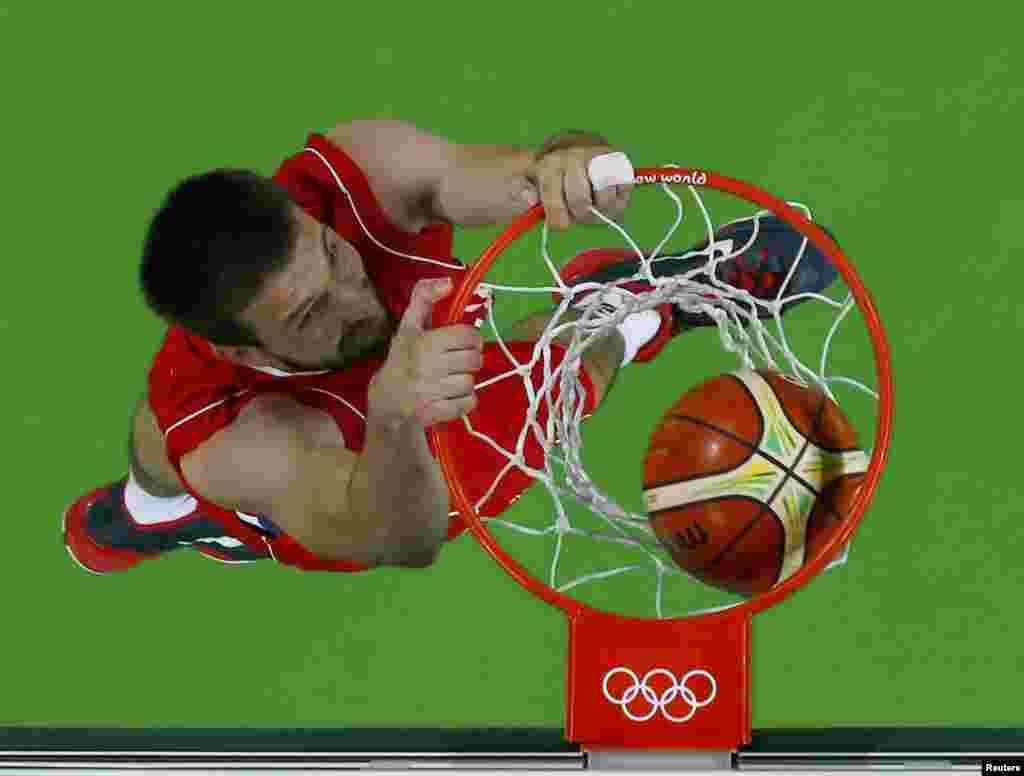 Serbia's Stefan Bircevic scores a slam dunk against Venezuela during an early round of the men's basketball competition. 