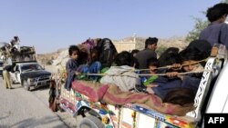 Displaced families flee from military operations against Taliban militants in South Waziristan on October 19.