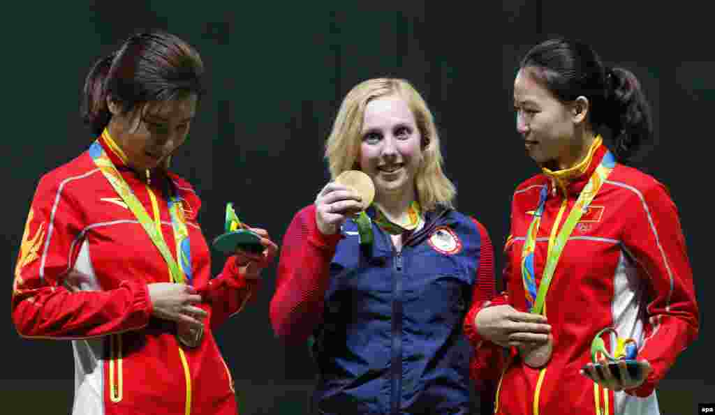Virginia Thrasher (center) from the United States celebrates after winning the first gold medal of the Rio Games in the 10-meter air rifle competition. 