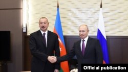 Russian President Vladimir Putin shakes hands with Azerbaijani President Ilham Aliyev during their meeting in Moscow, Russia, Sept. 1, 2018