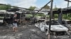 Жител стои до запалени автомобили на местото на напад со руски дрон, за време на рускиот напад врз Украина, во Дњепар, Украина, на 26 јули 2025 година.