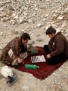 Afghanistan -- Men play chess in Kabul January 13, 2014.