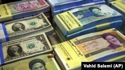 Iranian and U.S. banknotes on display at a currency exchange shop in downtown Tehran