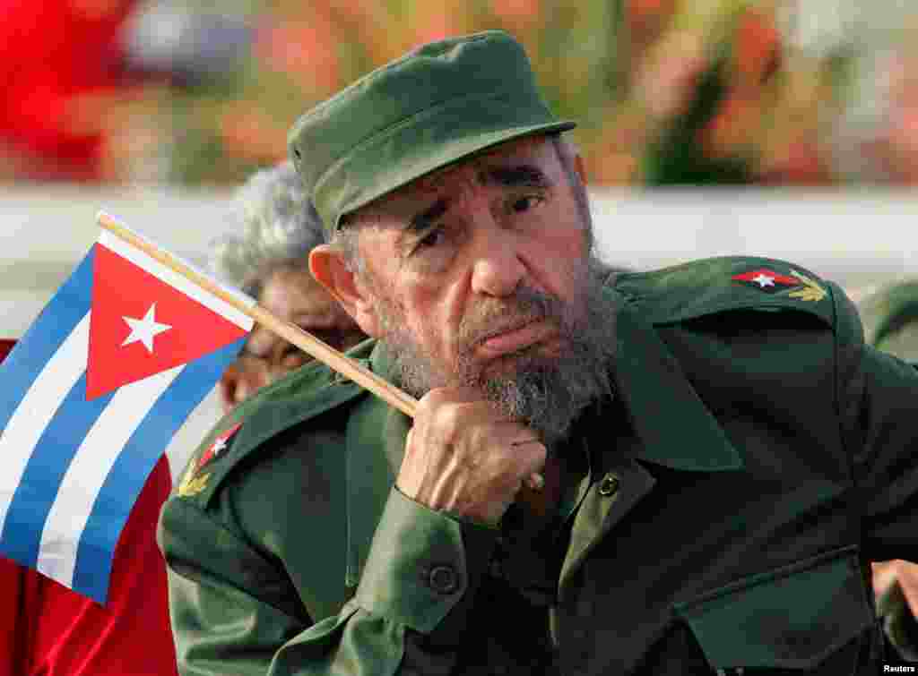 Držeći zastavu Kube, Fidel Castro sluša govor na majskoj paradi u Havani na Trgu revolucije, 2005.