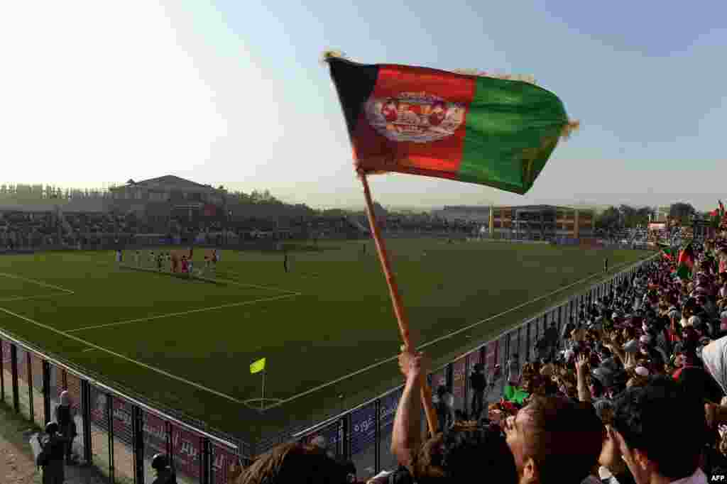Afghan fans celebrate following their team's second goal against Pakistan at the Afghanistan Football Federation Stadium in Kabul on August 20.